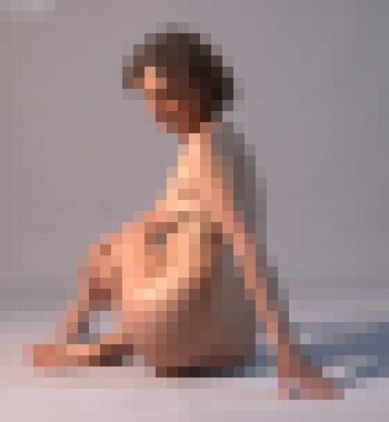 A back shot of a nude middle-aged woman with short dirty blonde curls sitting with her right leg tucked under her, her right arm holding her calf and her left arm draggign across the floor behind her, looking down over her left shoulder with a neutral expression