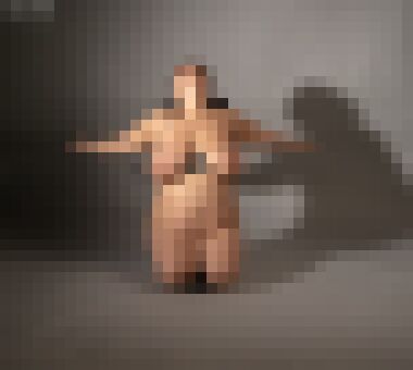 A nude white woman with brown pigtails kneeling with her arms out to the side and her head thrown back