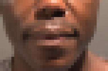 A close-up of a black man's mouth with a neutral expression